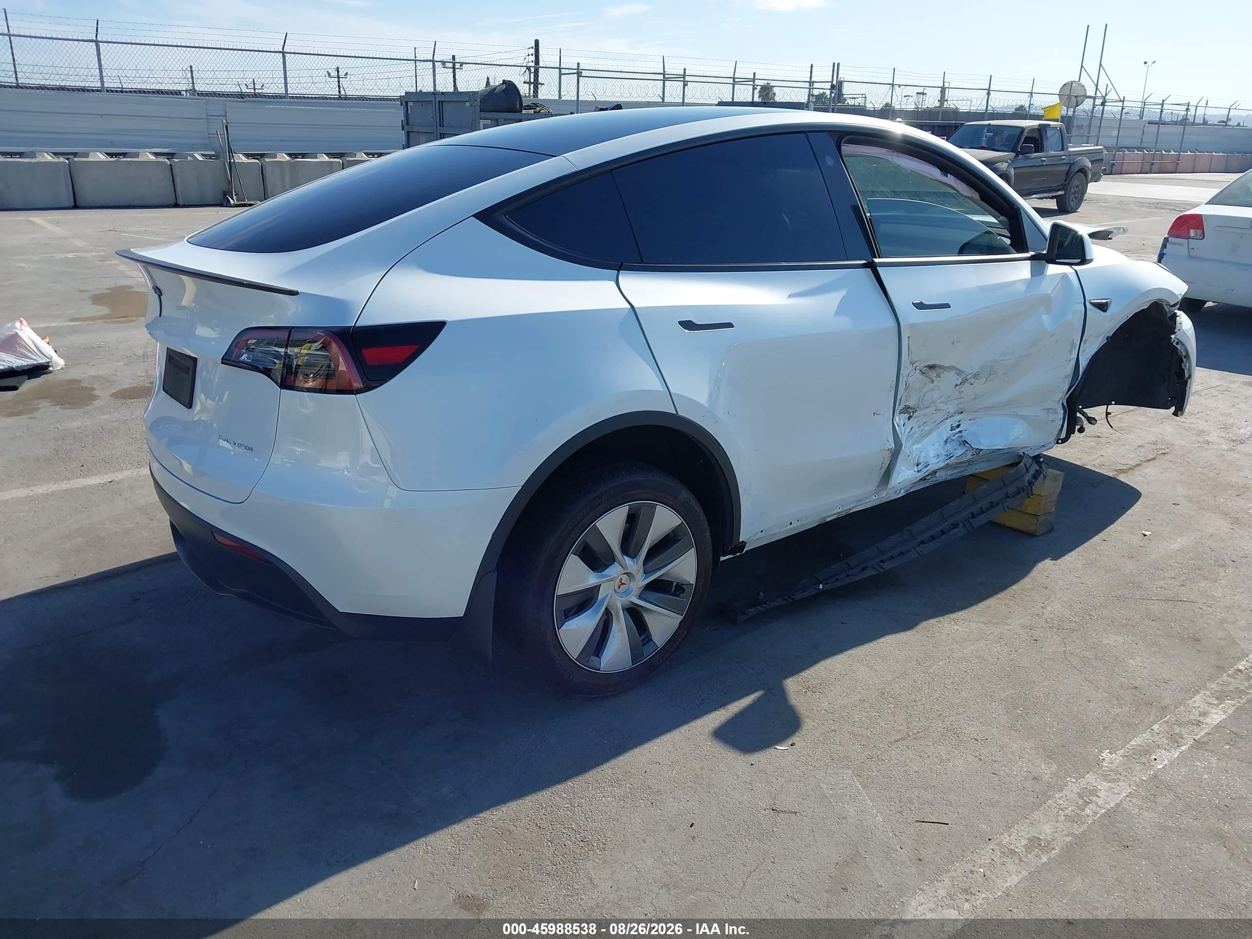 2023 Tesla Model Y VIN 7SAYGDEE2PA063588 IAAI salvage auction — Side, Salvage (California), sold $7,500 on 2026-09-11 (photo 4)