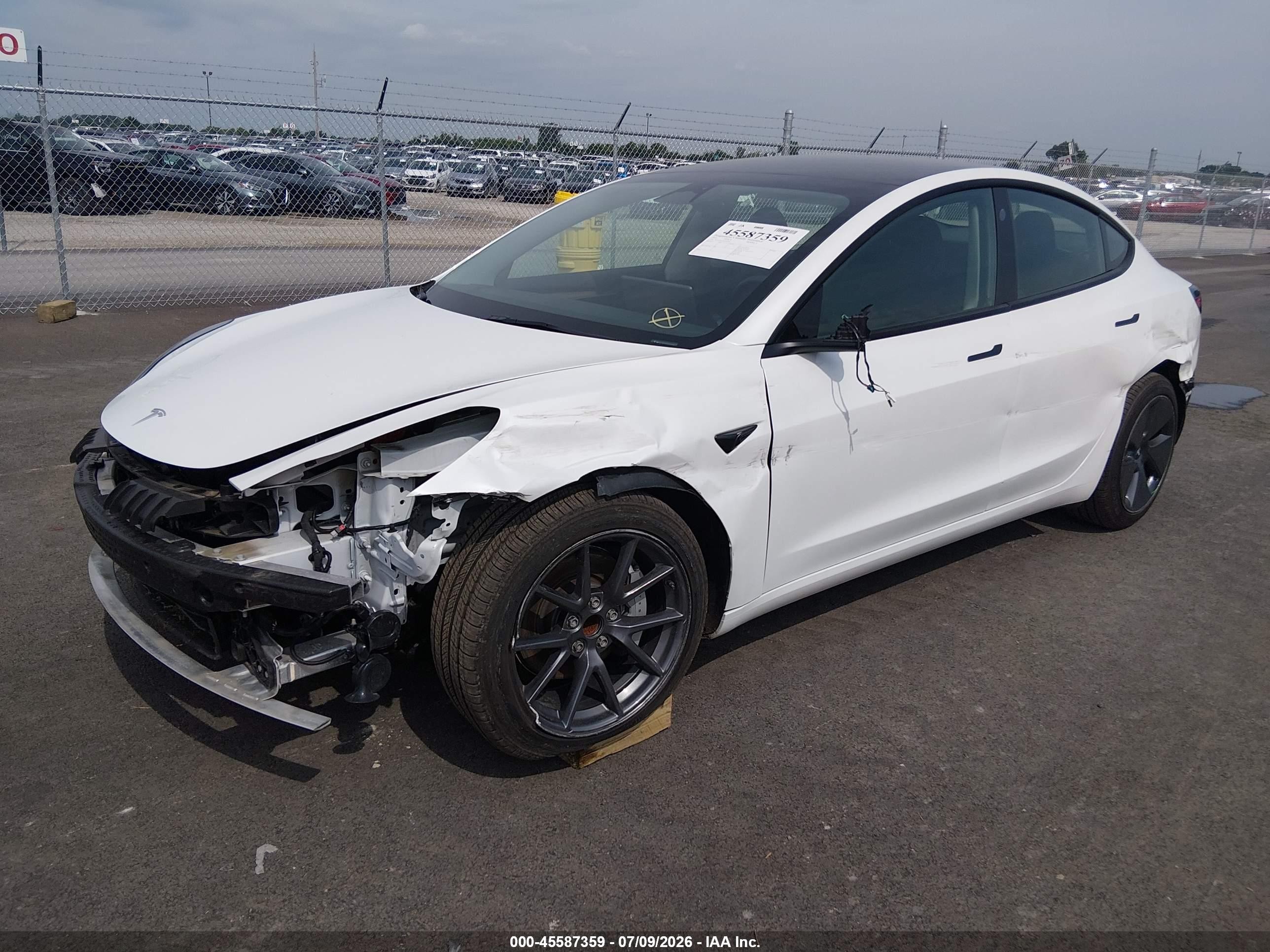 2023 Tesla Model 3 VIN 5YJ3E1EA1PF511346 IAAI salvage auction — Front & Rear, Salvage (Illinois), sold $8,600 on 2026-10-01 (photo 2)