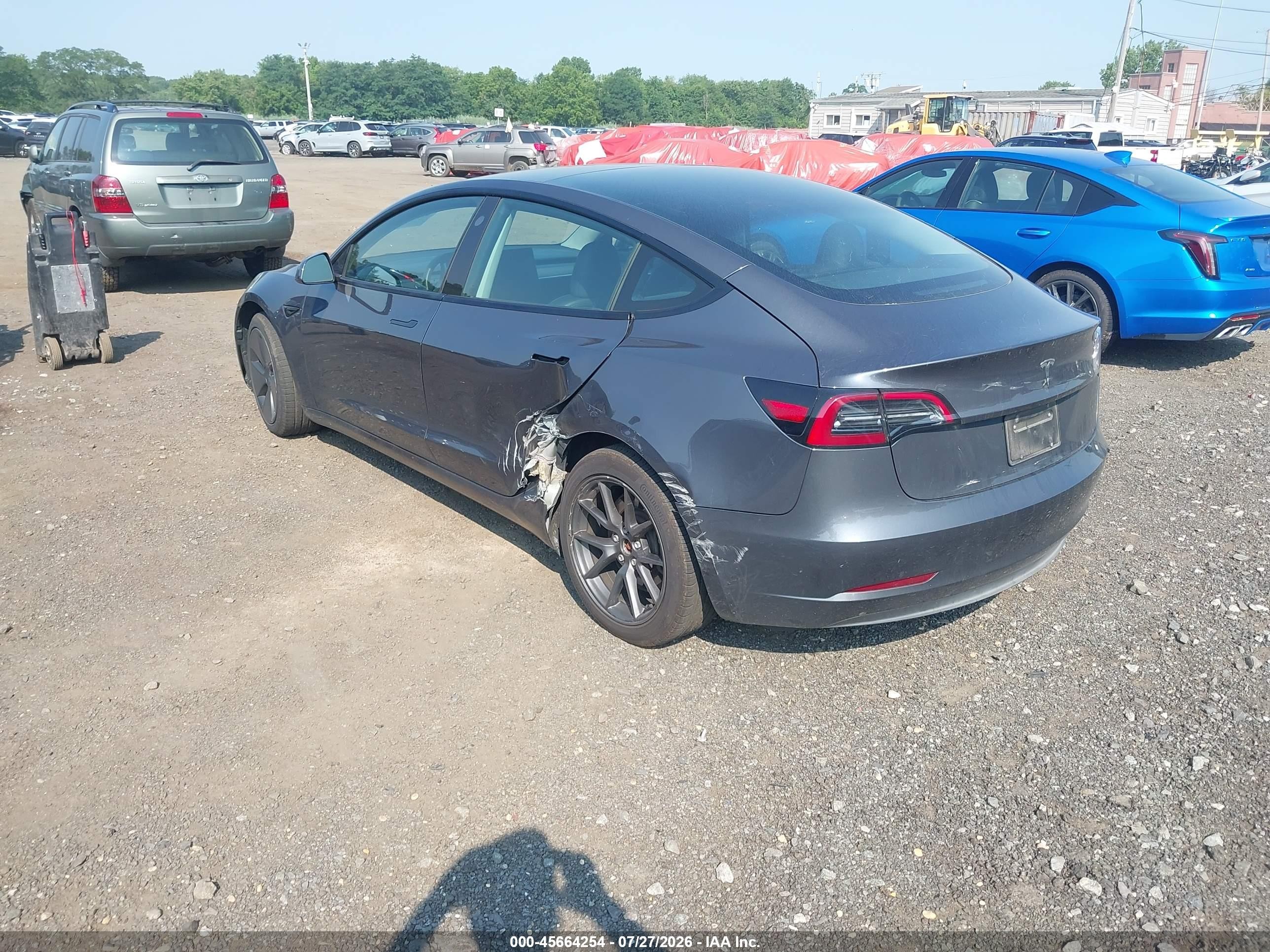 2023 Tesla Model 3 VIN 5YJ3E1EA2PF701799 IAAI salvage auction — Side, Salvage (Idaho), sold $8,600 on 2026-09-05 (photo 3)