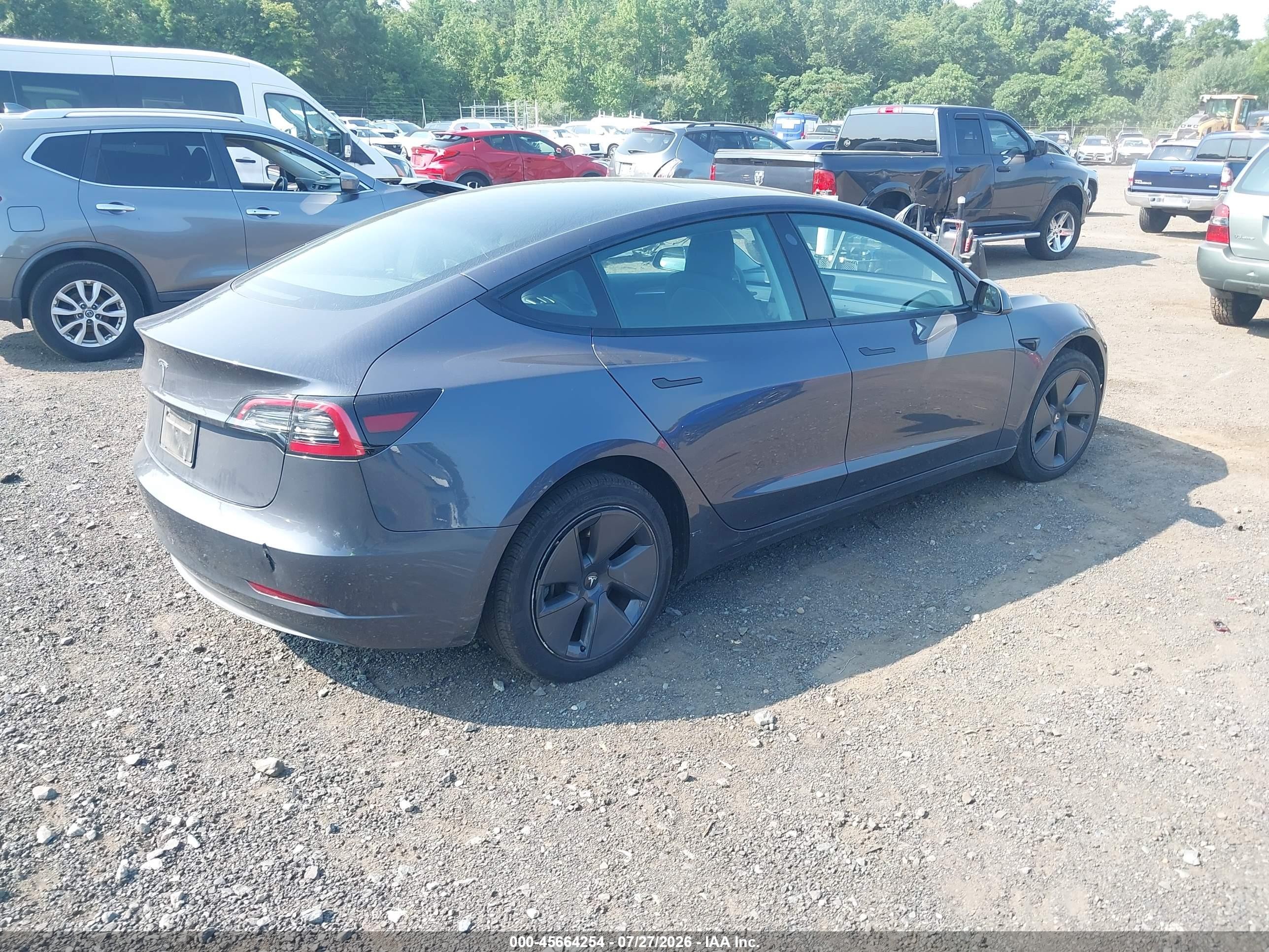 2023 Tesla Model 3 VIN 5YJ3E1EA2PF701799 IAAI salvage auction — Side, Salvage (Idaho), sold $8,600 on 2026-09-05 (photo 4)