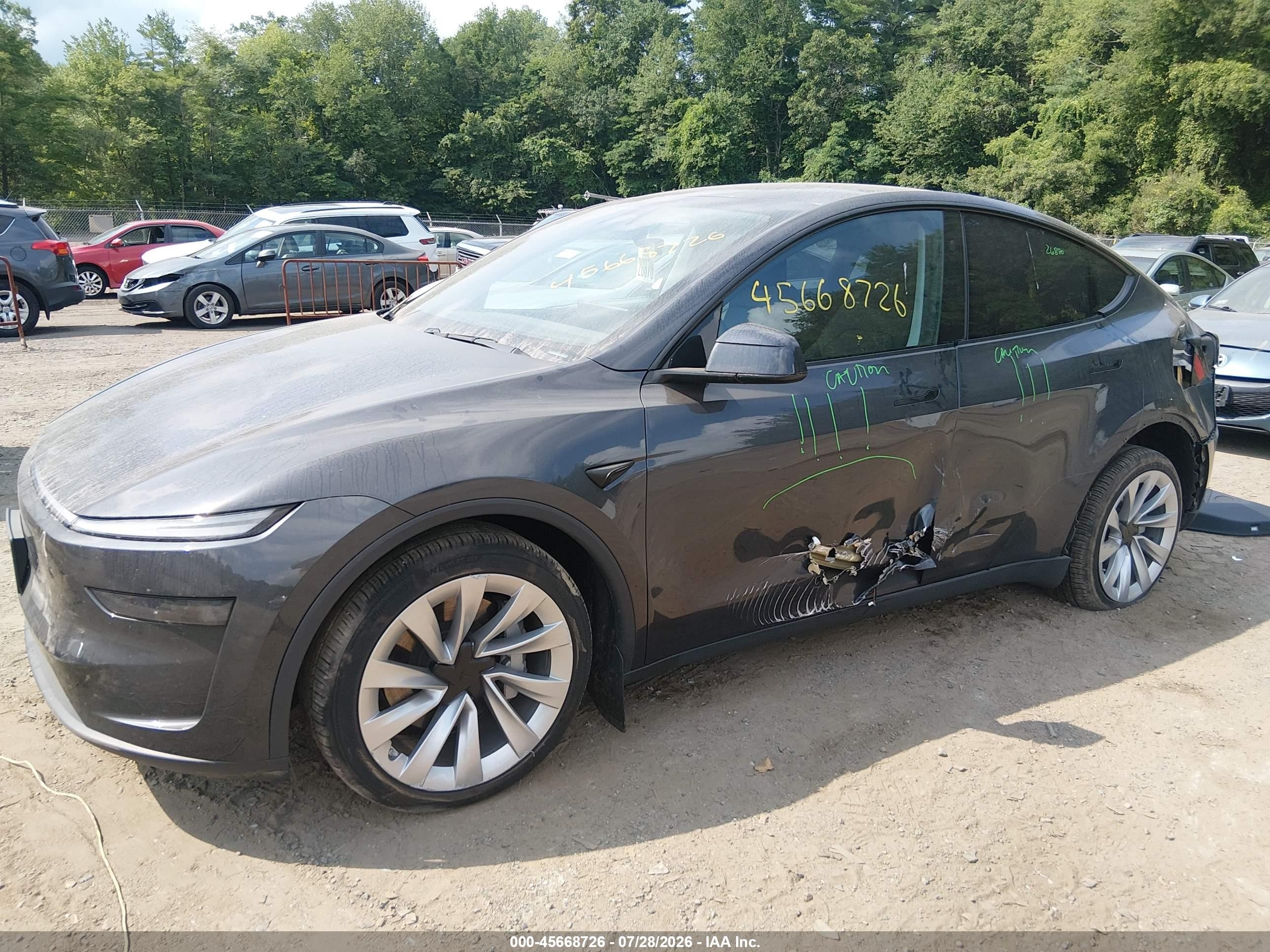 2026 Tesla Model y VIN 7SAYGDEEXTF388938 IAAI salvage auction — Side, Salvage (Idaho), sold $25,250 on 2026-10-08 (photo 2)