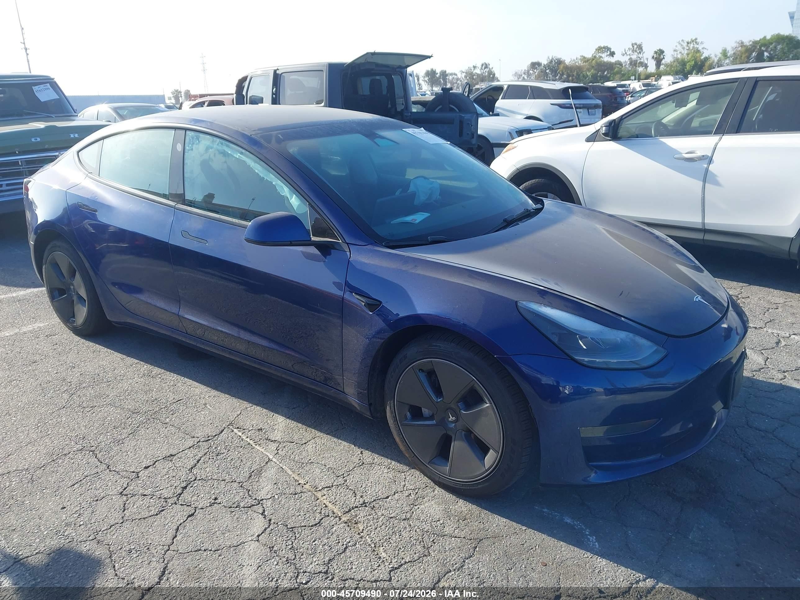 2023 Tesla Model 3 VIN 5YJ3E1EA4PF587921 — IAAI salvage auction photo