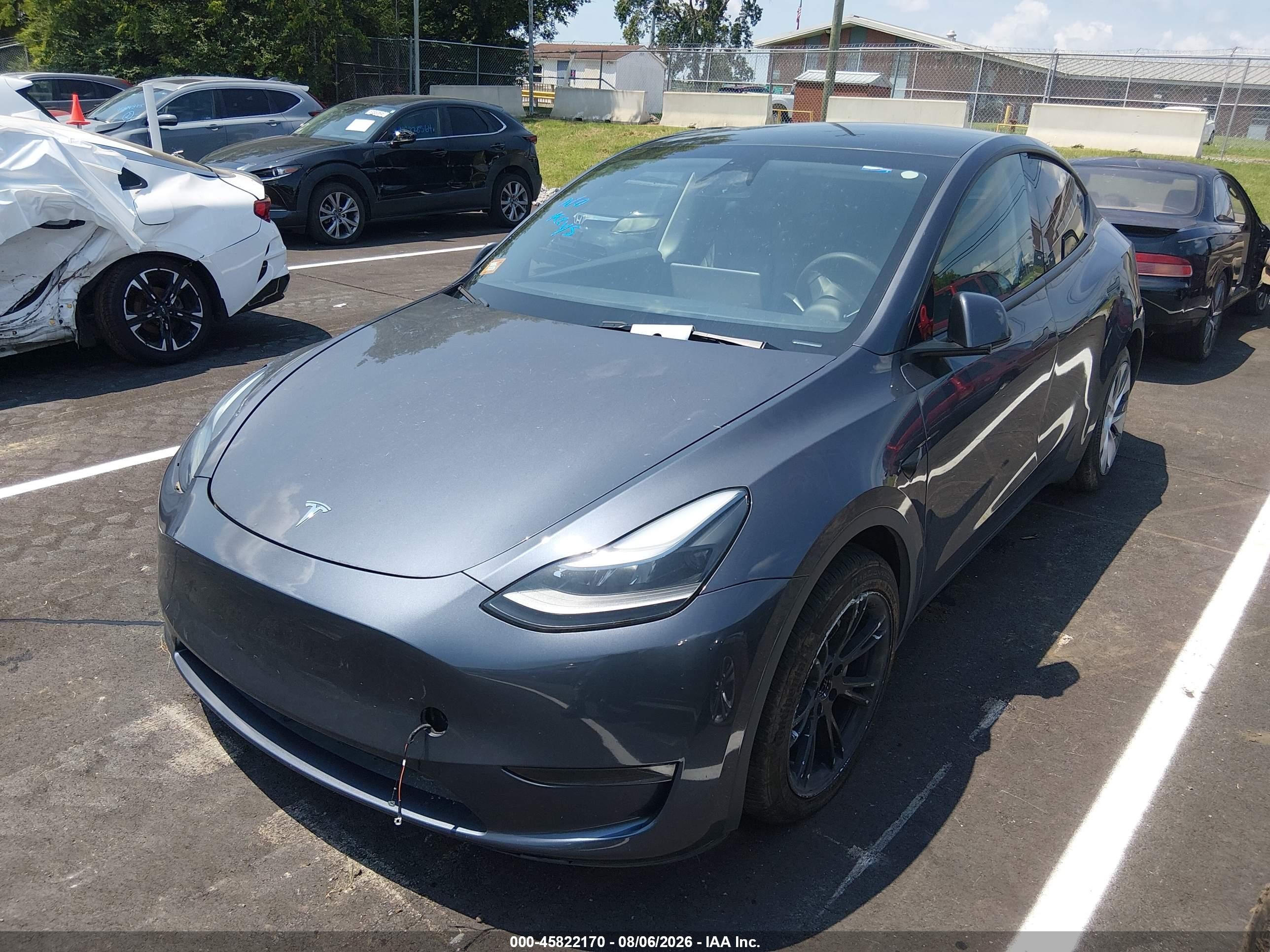 2023 Tesla Model Y VIN 7SAYGDED7PF948122 IAAI salvage auction — Side, Salvage (Tennessee), sold $8,600 on 2026-09-12 (photo 2)