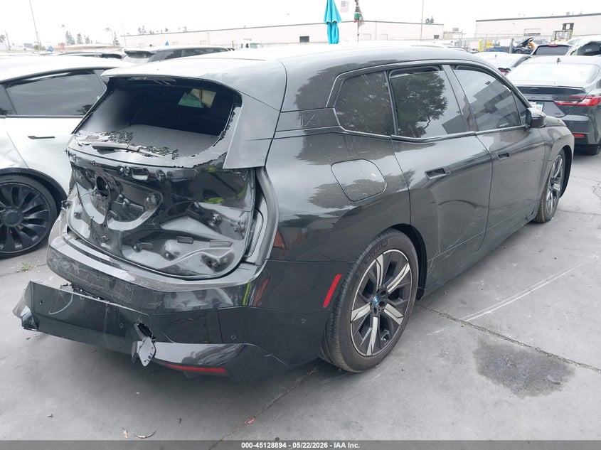 2023 BMW Ix VIN WB523CF06PCM54850 IAAI salvage auction — LEFT SIDE, Salvage Title, sold $11,650 on 2026-07-15 (photo 4)