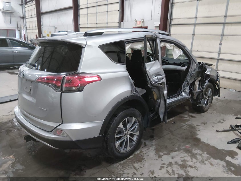 2018 Toyota Rav 4 VIN JTMRJREV0JD180961 IAAI salvage auction — SIDE, Salvage Title, sold $2,600 on 2026-07-24 (photo 4)