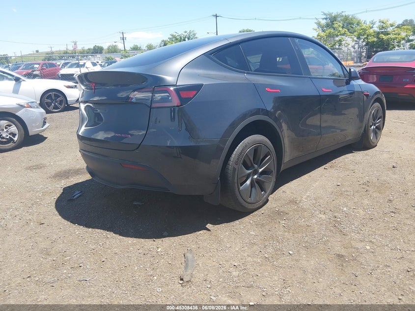 2024 Tesla Model y VIN 7SAYGDED5RF186542 IAAI salvage auction — SIDE, Salvage (Idaho), sold $7,300 on 2026-07-29 (photo 4)