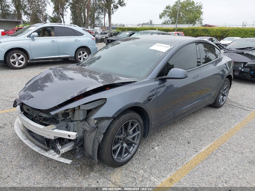 2023 Tesla Model 3 VIN 5YJ3E1EAXPF409754 IAAI salvage auction — FRONT & REAR, Salvage Title, sold $7,700 on 2026-07-07 (photo 2)