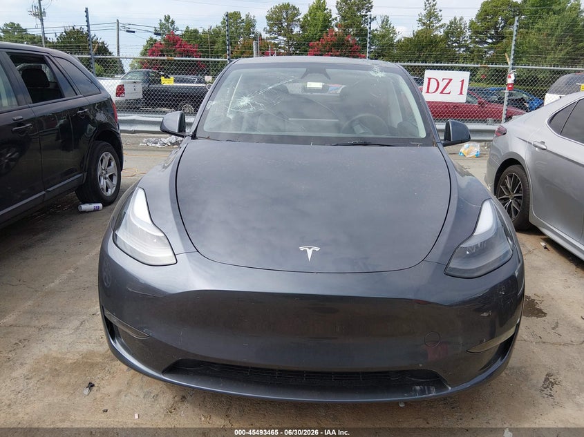 2023 Tesla Model y VIN 7SAYGDEE1PF881154 IAAI salvage auction — STORM DAMAGE, Salvage (Idaho), sold $11,000 on 2026-07-23 (photo 6)