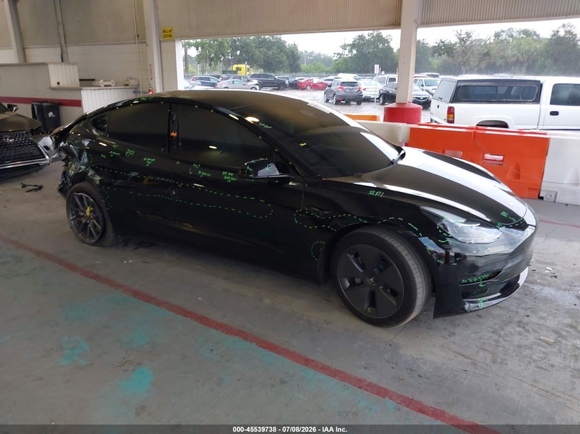 2023 Tesla Model 3 VIN 5YJ3E1EA0PF697574 — IAAI salvage auction photo