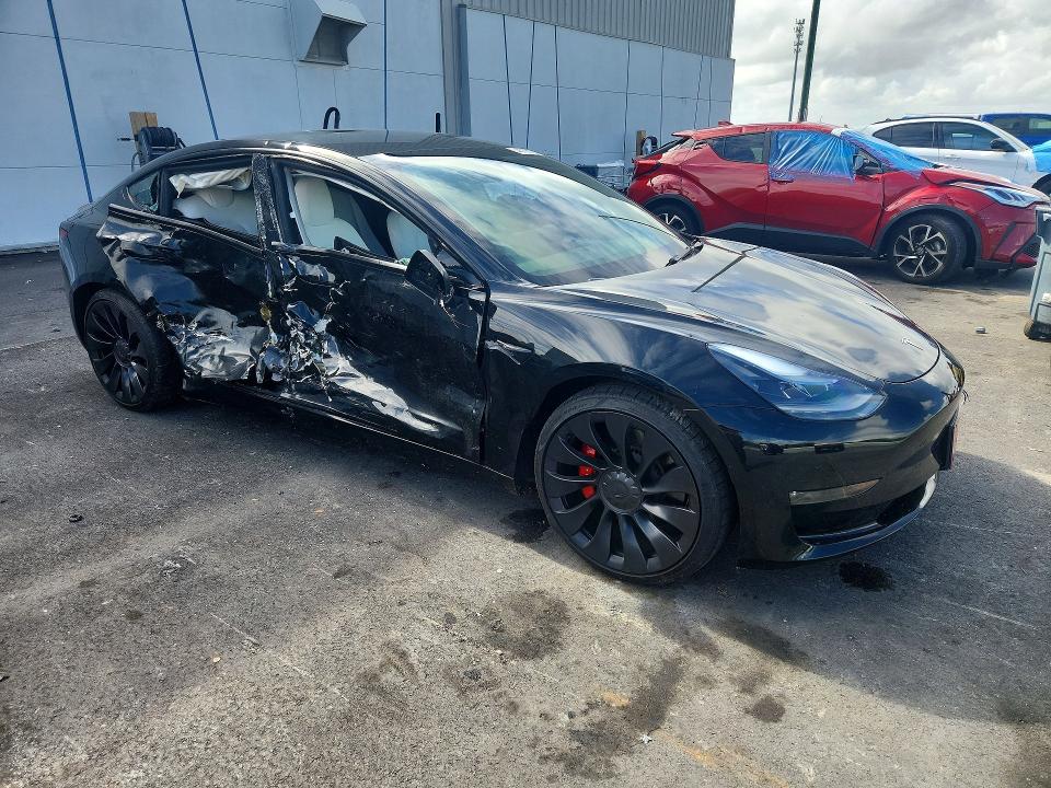 2023 Tesla Model 3 VIN 5YJ3E1EC2PF582671 COPART salvage auction — SIDE, FL, sold $7,900 on 2026-07-27 (photo 4)