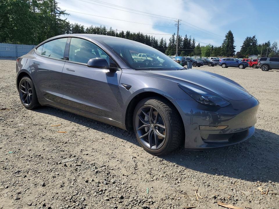 2023 Tesla Model 3 VIN 5YJ3E1EA4PF701982 COPART salvage auction — SIDE, Salvage Title, sold $7,800 on 2026-07-10 (photo 4)