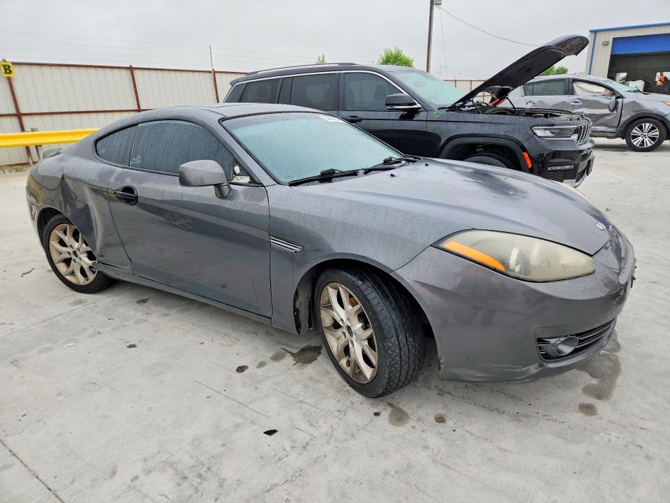 2007 Hyundai Tiburon VIN KMHHN66FX7U259922 COPART salvage auction — REAR END, TX - SALVAGE VEHICLE TITLE, sold $325 on 2026-07-31 (photo 4)