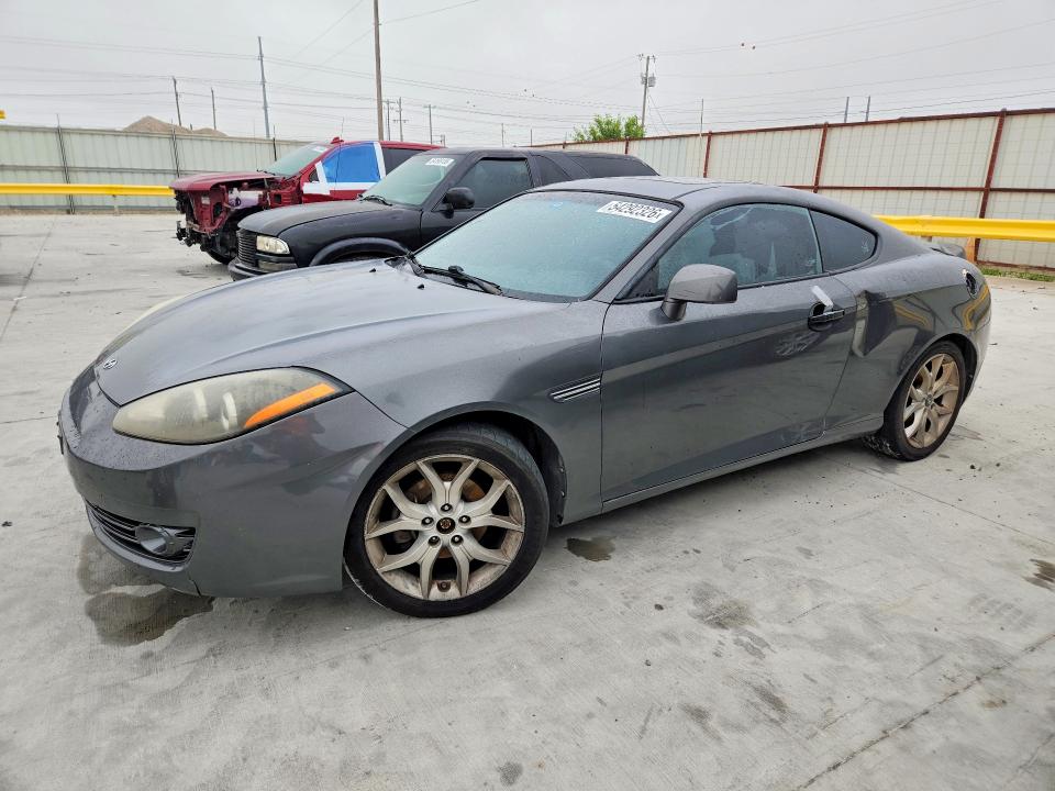 2007 Hyundai Tiburon VIN KMHHN66FX7U259922 COPART salvage auction — REAR END, TX - SALVAGE VEHICLE TITLE, sold $325 on 2026-07-31 (photo 1)