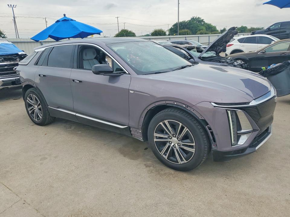 2024 Cadillac Lyriq VIN 1GYKPRRL4RZ131621 COPART salvage auction — SIDE, Tx - Salvage Vehicle Title, sold $16,600 on 2026-07-09 (photo 4)