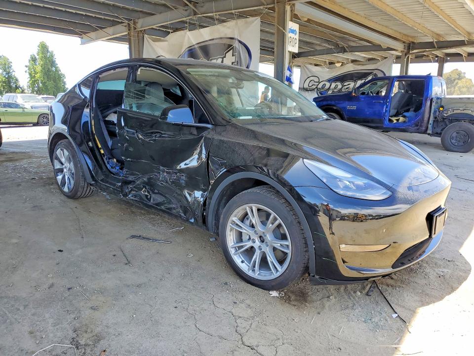2023 Tesla Model y VIN 7SAYGDEE2PF892342 COPART salvage auction — SIDE, CA - SALVAGE CERTIFICATE, sold $7,800 on 2026-07-21 (photo 4)