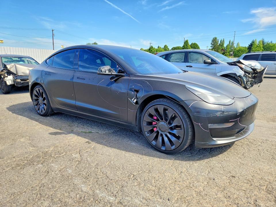2022 Tesla Model 3 VIN 5YJ3E1EC7NF129773 COPART salvage auction — SIDE, Or - Salvage Title Certificate, sold $1,050 on 2026-07-29 (photo 4)