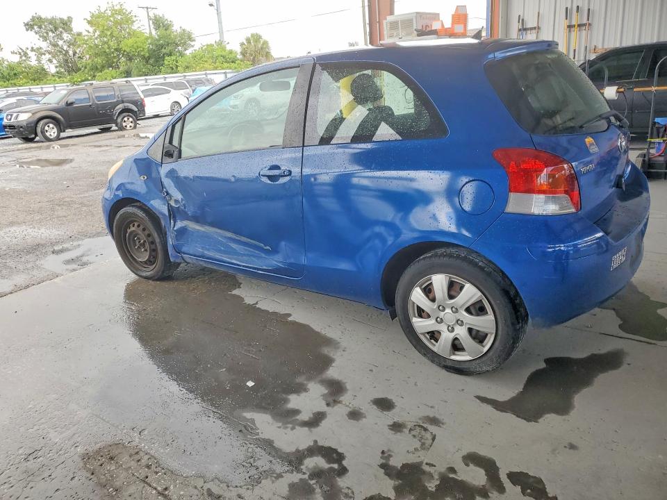 2010 Toyota Yaris VIN JTDJT4K33A5288689 COPART salvage auction — SIDE, Fl - Cert Of Title Slvg Rebuildable, sold $850 on 2026-07-06 (photo 2)