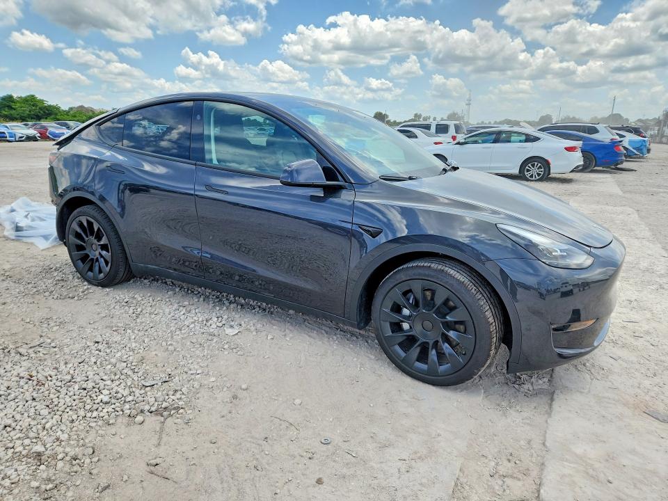 2024 Tesla Model y VIN 7SAYGDEDXRF050990 COPART salvage auction — REAR END, Fl - Cert Of Title Slvg Rebuildable, sold $8,600 on 2026-07-09 (photo 4)