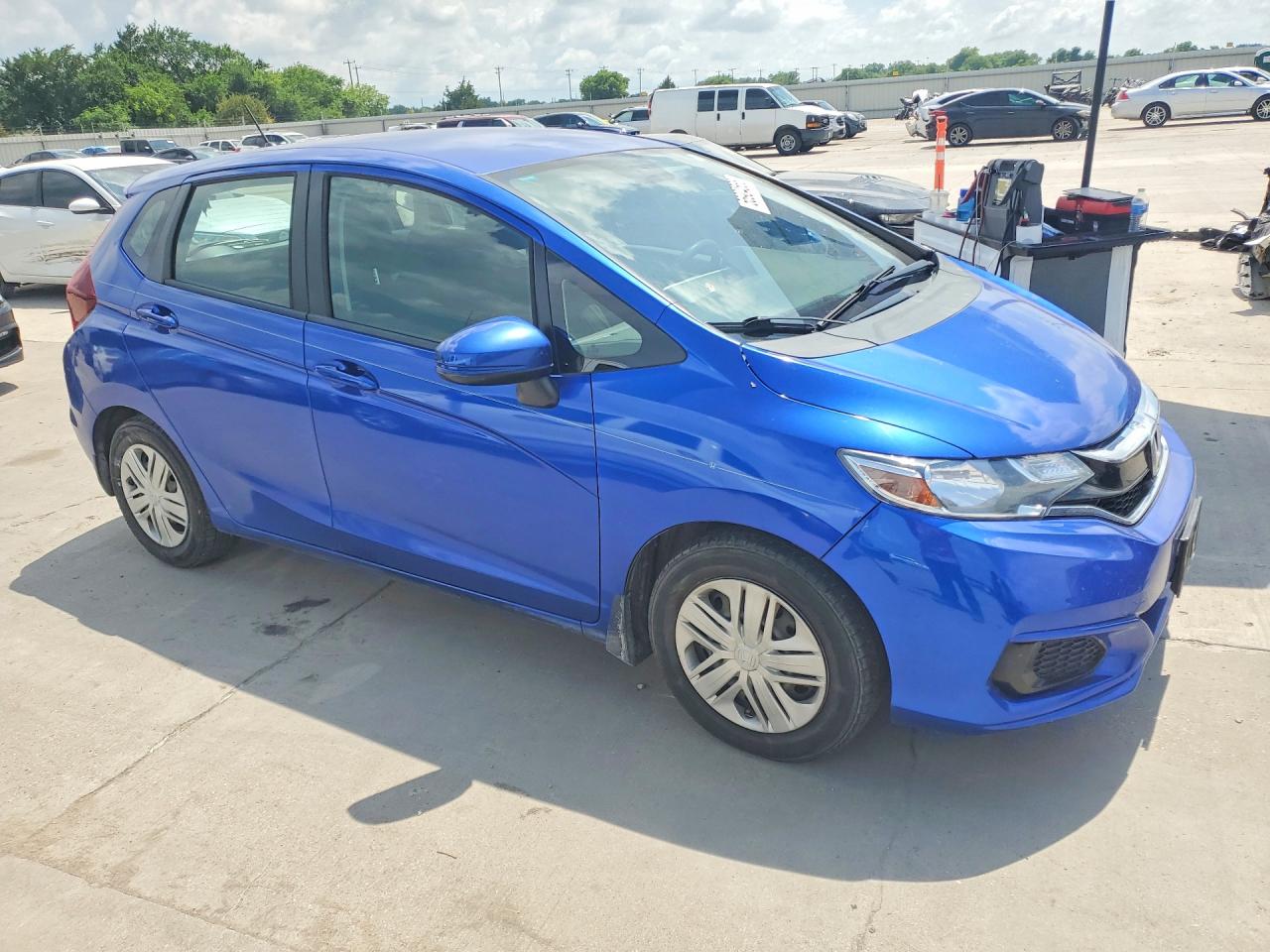 2019 Honda Fit VIN 3HGGK5H4XKM700090 COPART salvage auction — Side, TX - SALVAGE VEHICLE TITLE, sold $2,250 on 2026-07-09 (photo 4)
