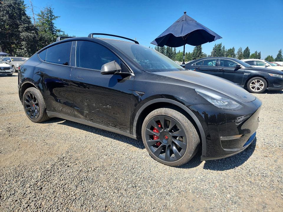 2023 Tesla Model y VIN 7SAYGDEE0PA105031 COPART salvage auction — REAR END, WA - BILL OF SALE, sold $15,700 on 2026-08-28 (photo 4)