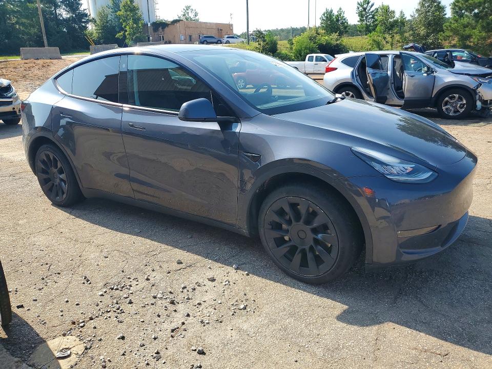 2023 Tesla Model y VIN 7SAYGDEE2PA027741 COPART salvage auction — SIDE, Nj - Certificate Of Title (P), sold $22,750 on 2026-09-22 (photo 4)