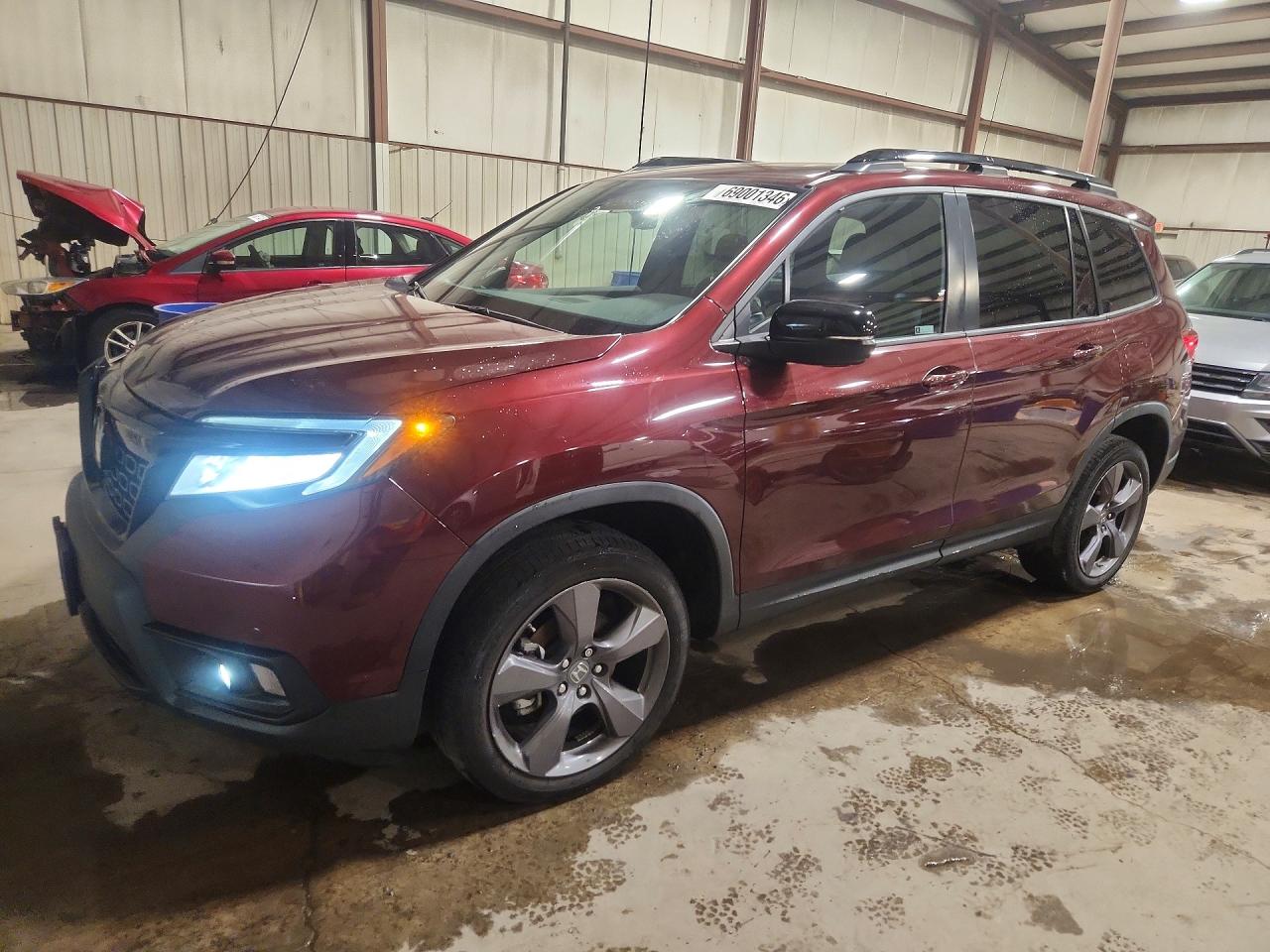2021 Honda Passport VIN 5FNYF8H98MB029093 — COPART salvage auction photo