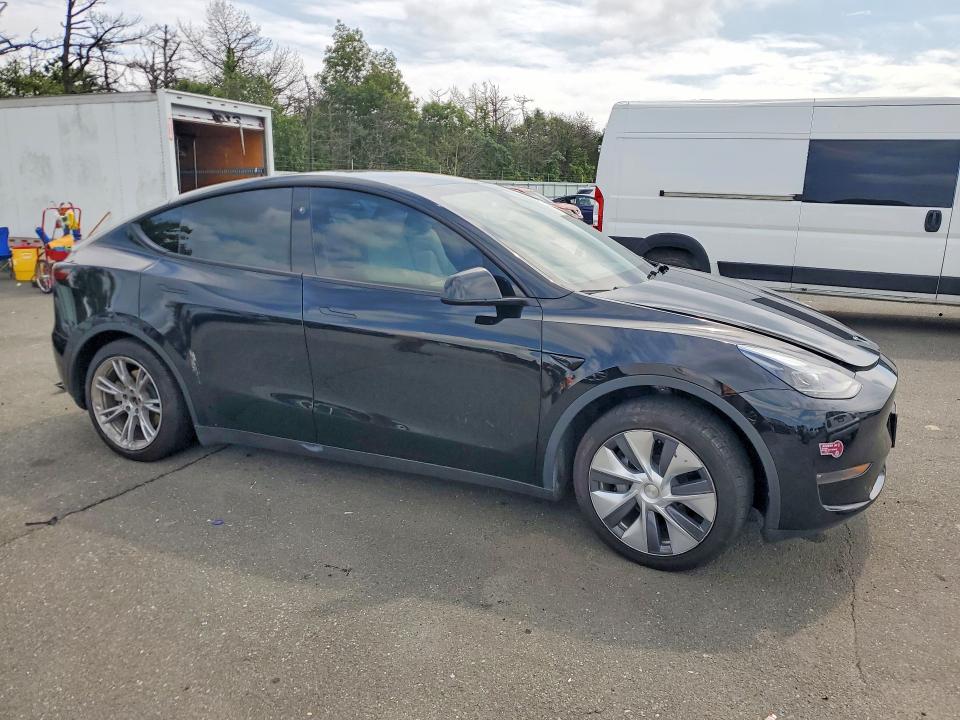 2023 Tesla Model y VIN 7SAYGAEE8PF861529 COPART salvage auction — WATER/FLOOD, NY, sold $10,900 on 2026-10-03 (photo 4)